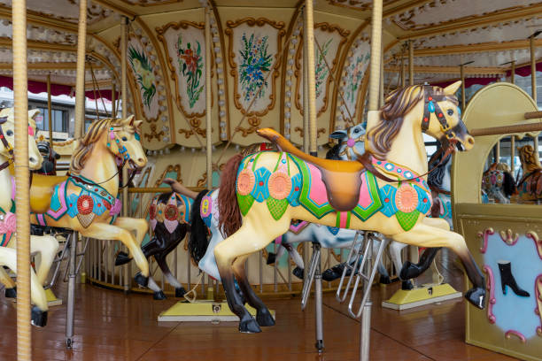 Colorful horses on a carousel at a fair in a small town in Europe.
